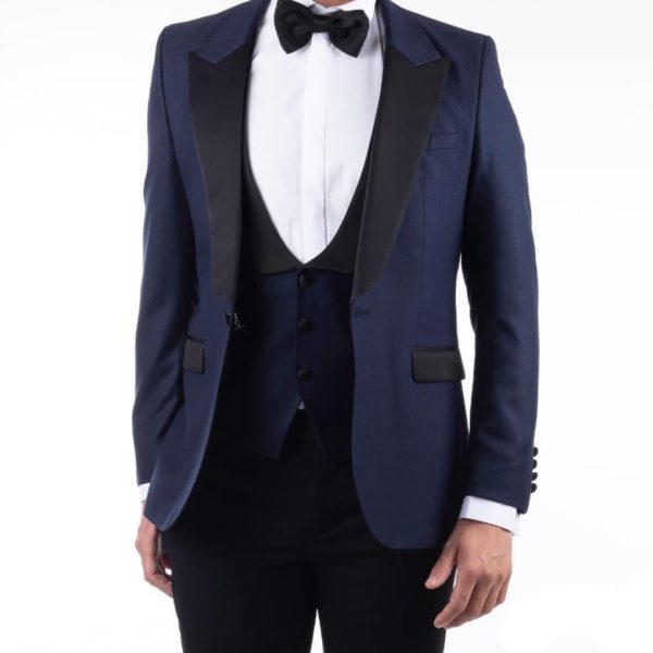 A slim-fit dark blue tuxedo with a plain patterned lapel.
