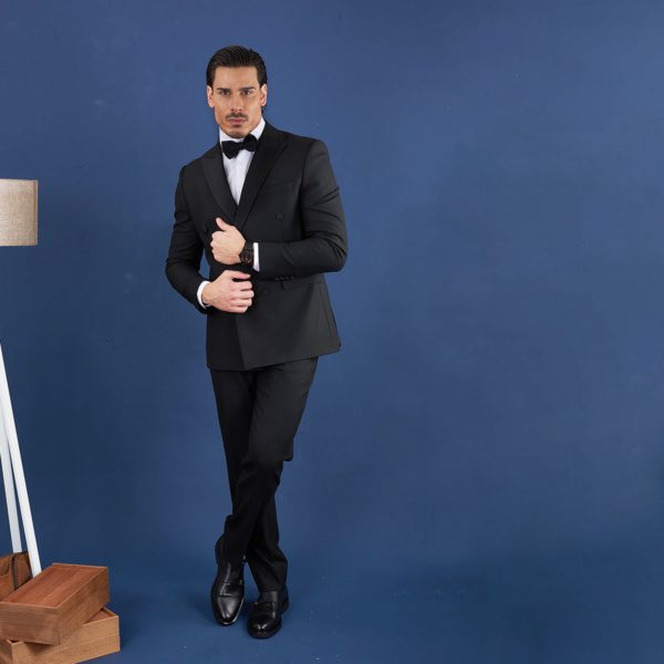 A black wedding suit, with a single-breasted jacket and tapered pants.